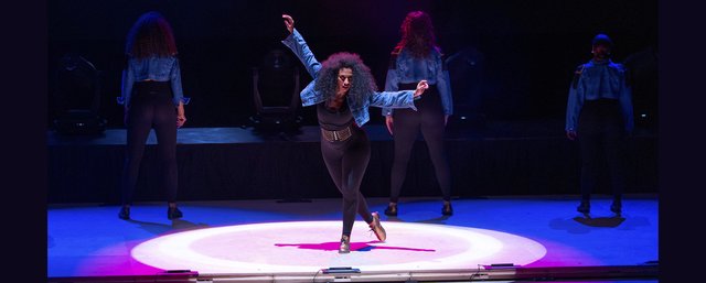 Syncopated Ladies tap dancers performing onstage in matching costumes