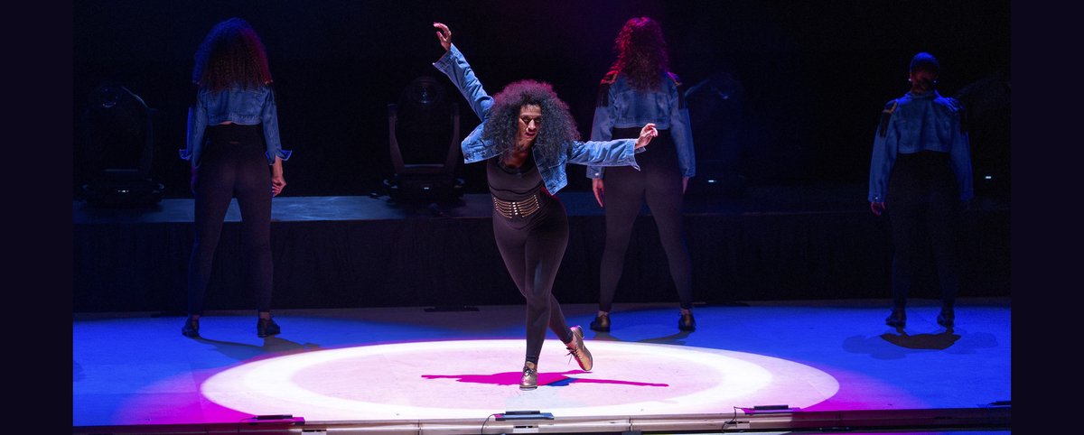 Syncopated Ladies tap dancers performing onstage in matching costumes