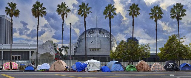 Panoramic photograph of tents lined along a Los Angeles street beneath palm trees, with a domed museum building behind