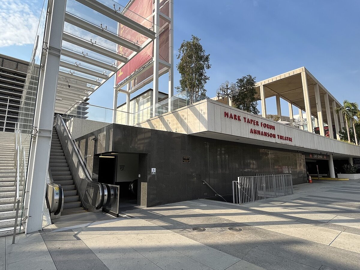 Plaza-level entrance and signage for the Mark Taper Forum and Ahmanson Theatre at the Music Center, with an escalator and staircase