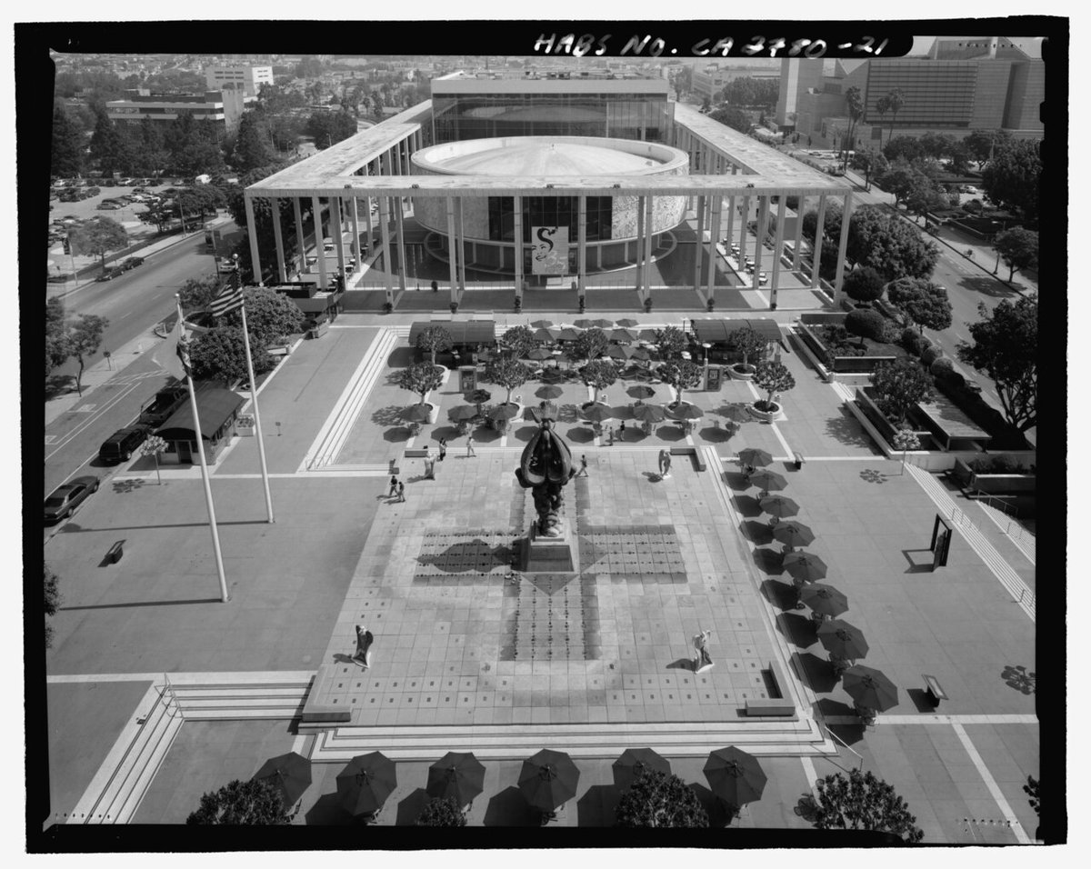 Black-and-white aerial view of the Music Center plaza on Grand Avenue, with its fountain and umbrella tables facing the theater buildings