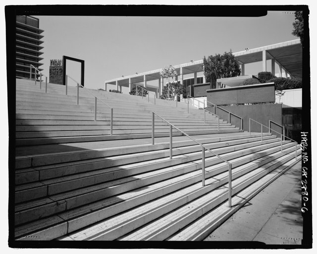 Black-and-white view of the wide main staircase at the Los Angeles Music Center with the theater colonnade above