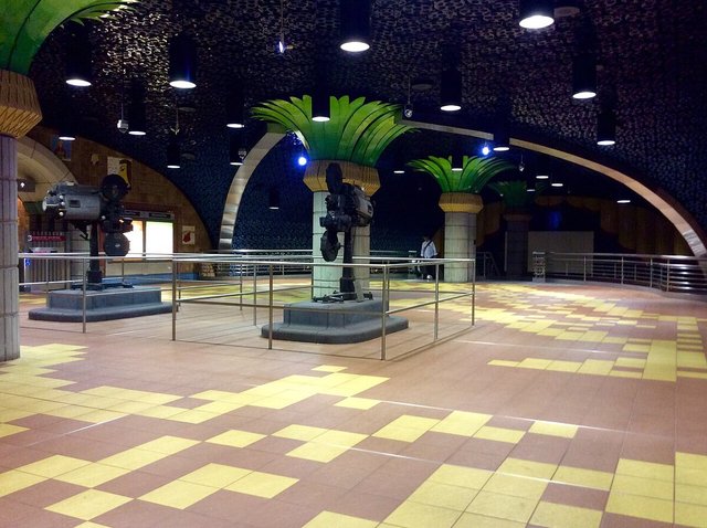 Hollywood/Vine Metro station concourse with film projectors and palm-topped columns, a short walk from the Pantages