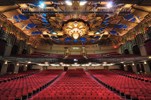 Red seats and the ornate Art Deco ceiling inside the Hollywood Pantages Theatre