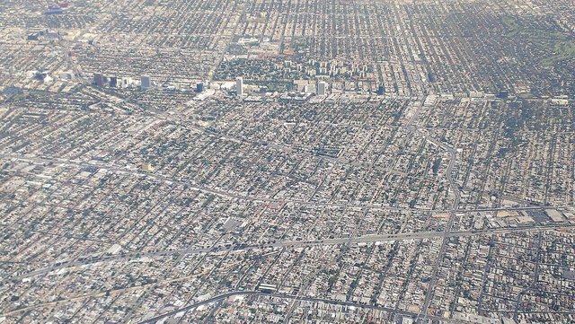 Aerial view of the Mid-Wilshire grid of Los Angeles streets with towers along Wilshire Boulevard