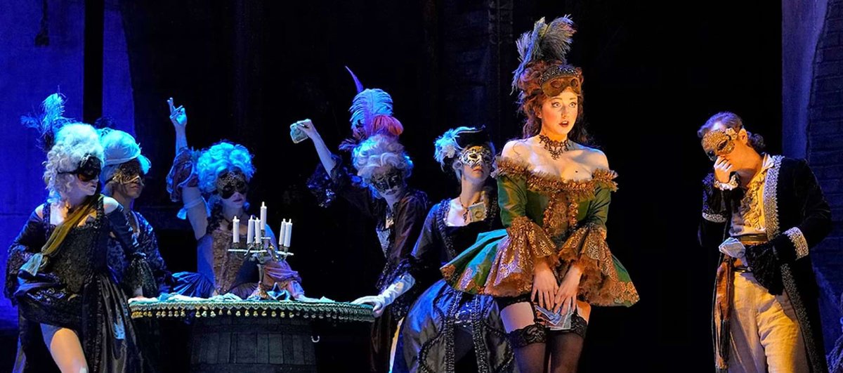Promotional artwork for Los Angeles Opera's production of Candide featuring dramatic theatrical staging