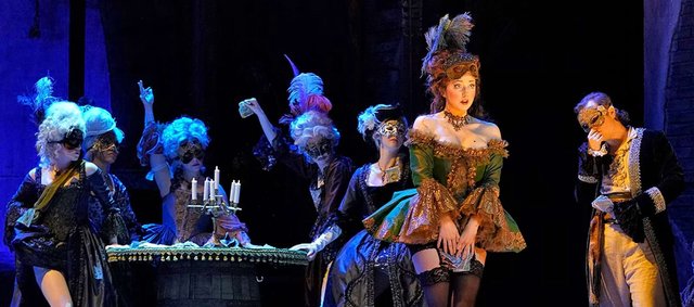 Promotional artwork for Los Angeles Opera's production of Candide featuring dramatic theatrical staging