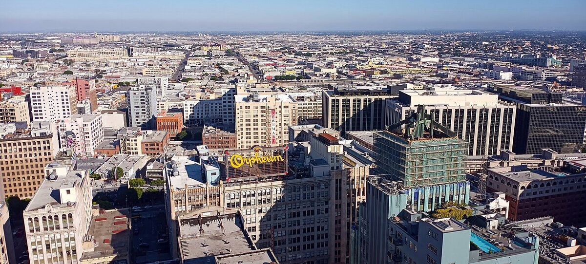 Aerial view of downtown Los Angeles with the yellow Orpheum rooftop sign in the foreground