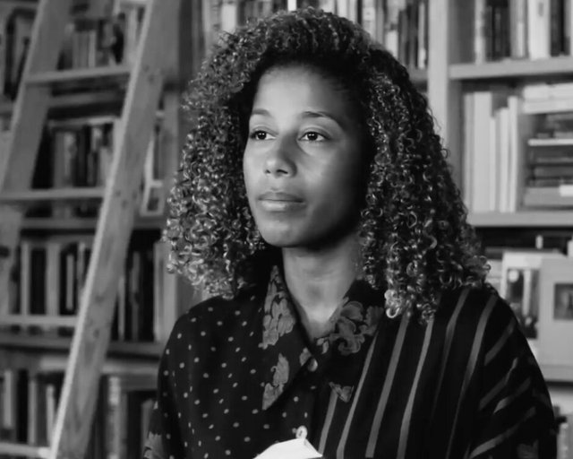 Black-and-white portrait of poet Aja Monet