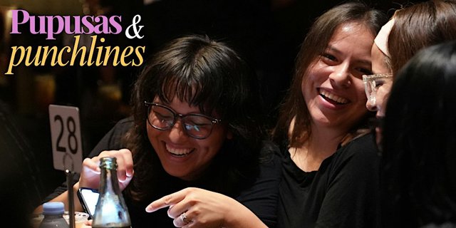 Audience members laughing at a restaurant table during Pupusas and Punchlines, with the show's purple and gold logo in the corner