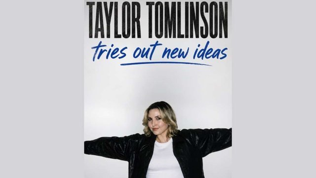 Taylor Tomlinson in a black jacket with arms spread wide under the words "tries out new ideas"
