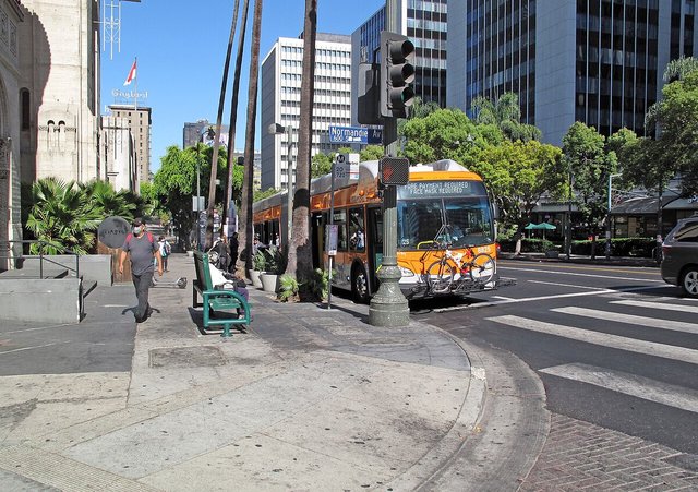 Pedestrians and a Metro bus at Wilshire Boulevard and Normandie Avenue in Los Angeles