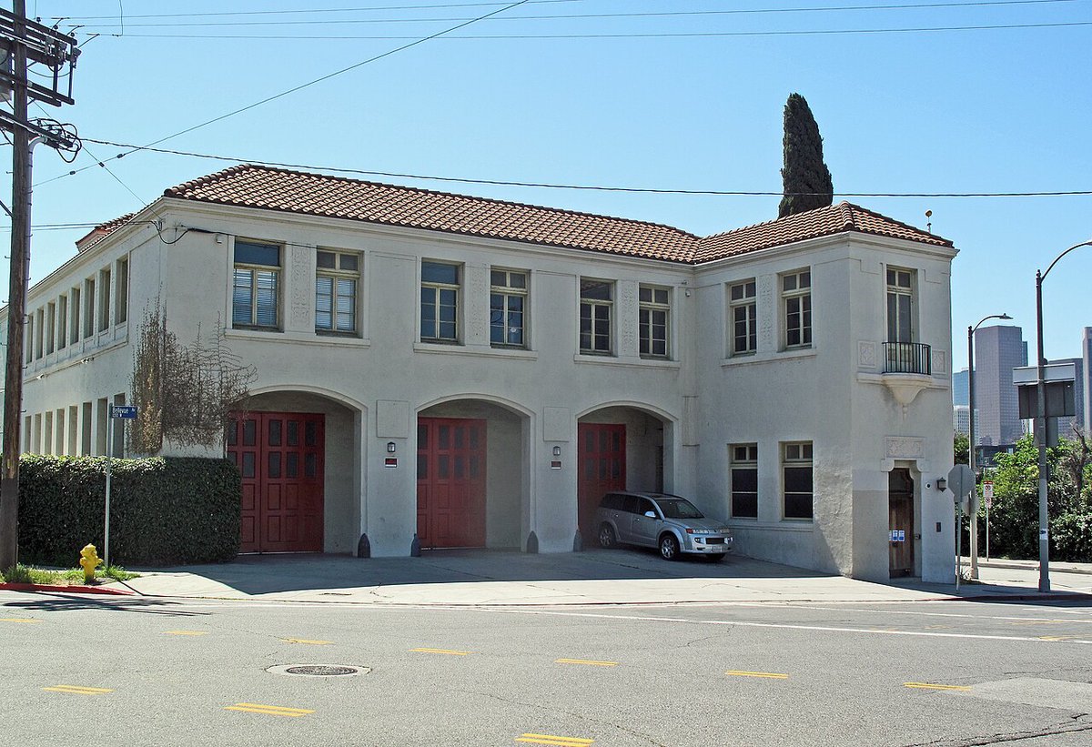 Old Fire Station 6, a stucco building with red arched doors, on a street corner near Echo Park