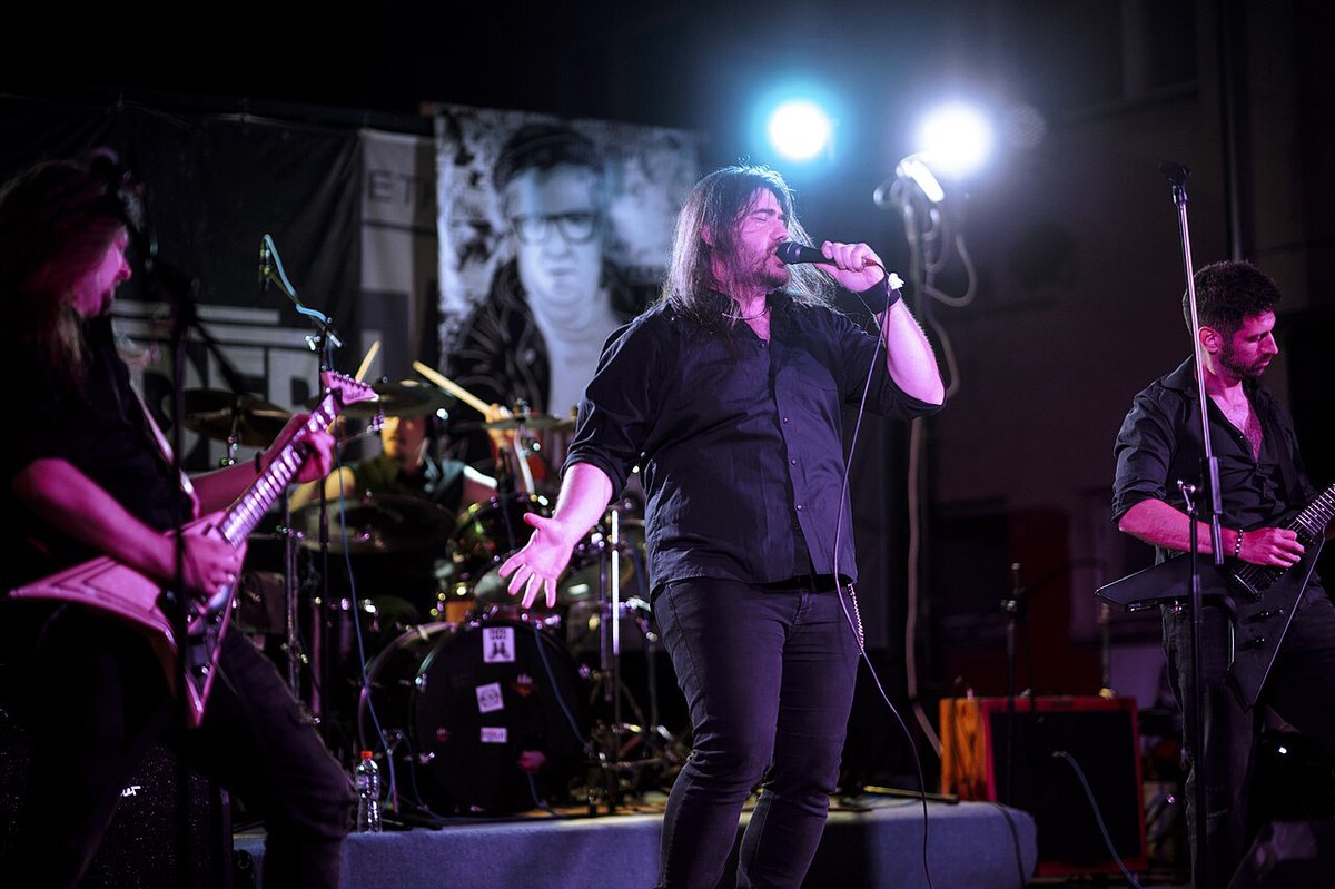A band playing on stage with a spotlit vocalist