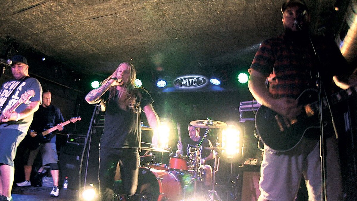 Close Your Eyes performing live on stage, guitarist and vocalist energizing the crowd