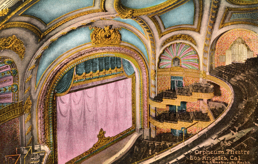 Vintage hand-colored postcard of the Orpheum Theatre auditorium, with gilded balconies and a pink stage curtain