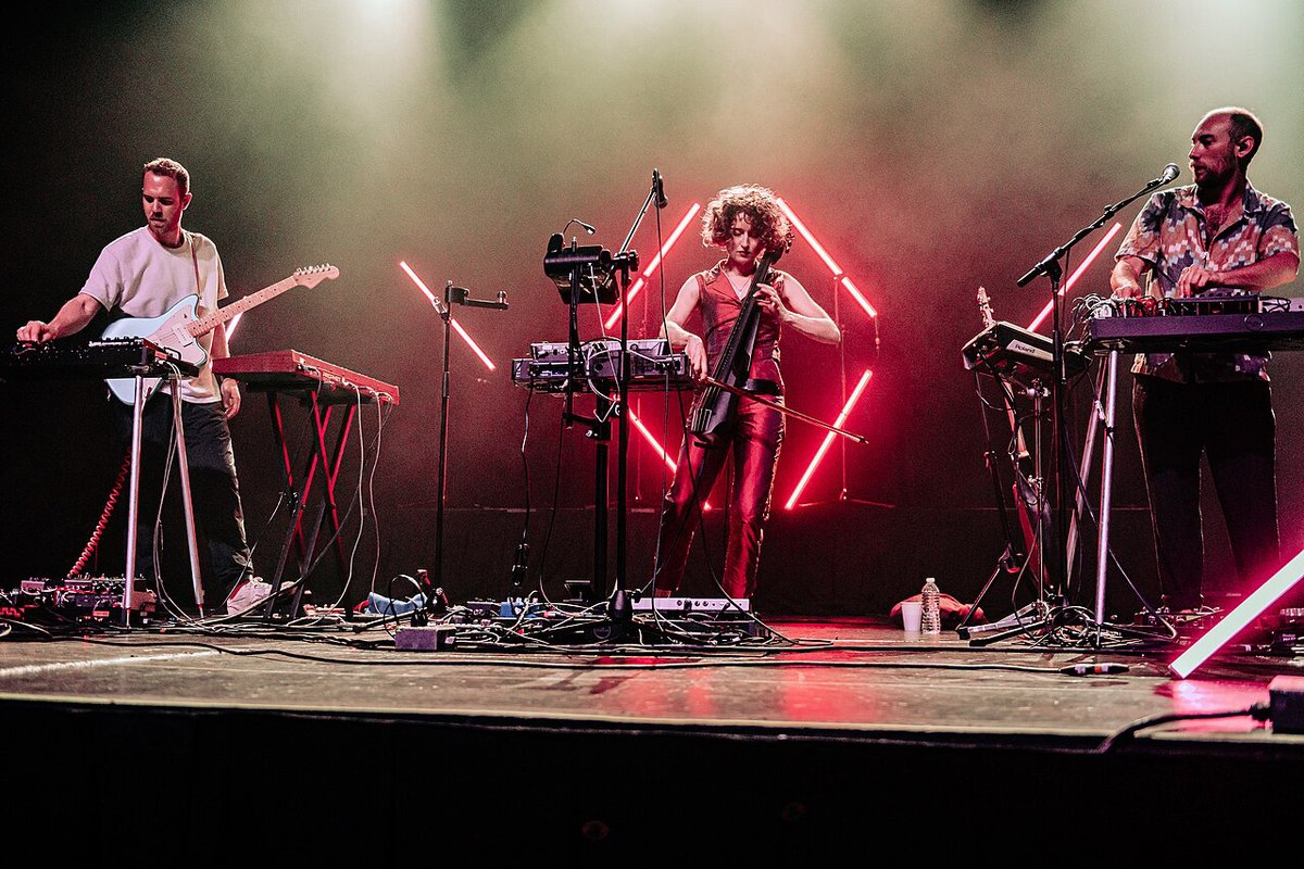 Elder Island performing on a Los Angeles stage under colored concert lights
