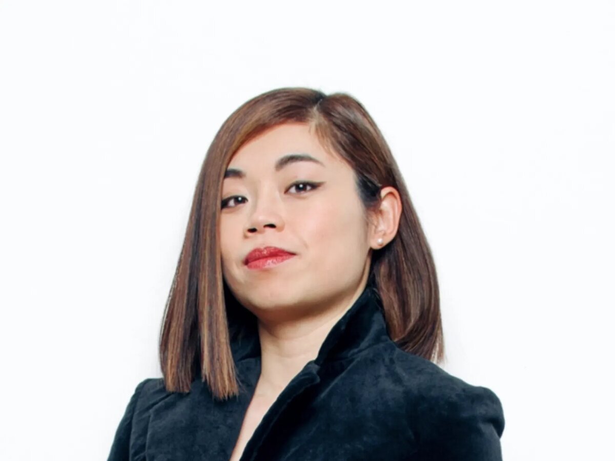 Studio portrait of conductor Elim Chan against a white background