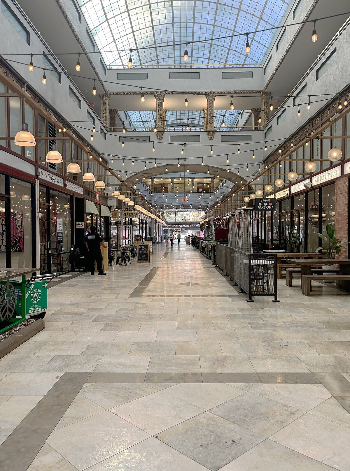 Skylit interior arcade with string lights and shops in the Broadway Arcade in downtown Los Angeles