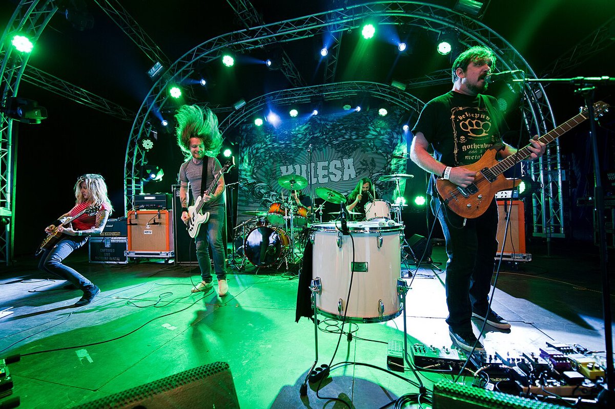 Kylesa performing live on stage with dual drummers and heavy fog lighting