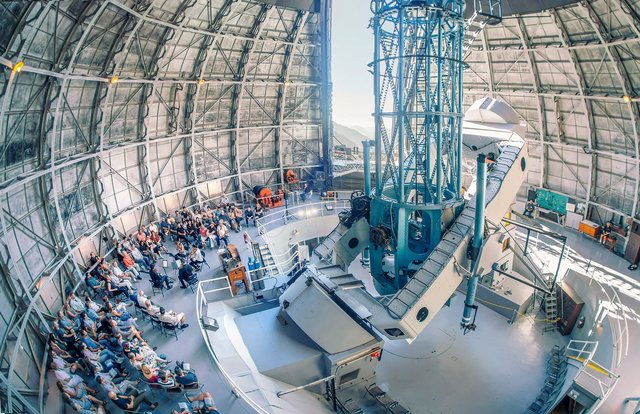 Audience seated for a chamber concert beneath the 100-inch telescope inside the Mount Wilson Observatory dome