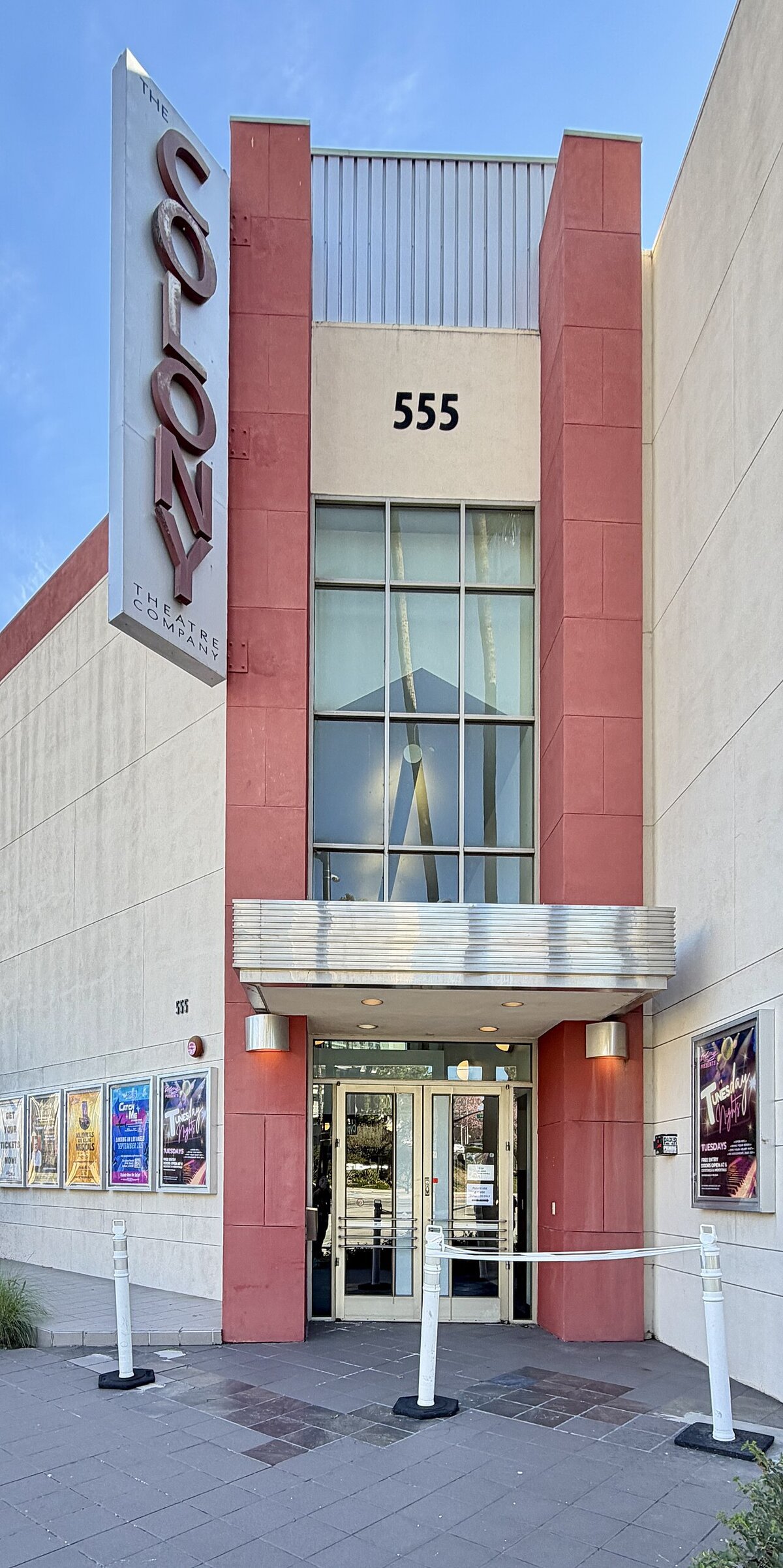 Street entrance of the Colony Theatre in Burbank with its vertical sign and 555 above the doors