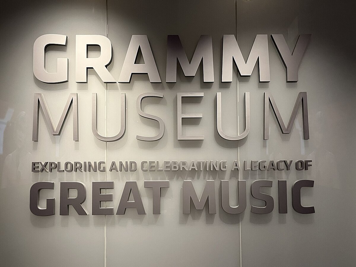 Brushed-metal Grammy Museum lettering on a wall reading Exploring and Celebrating a Legacy of Great Music
