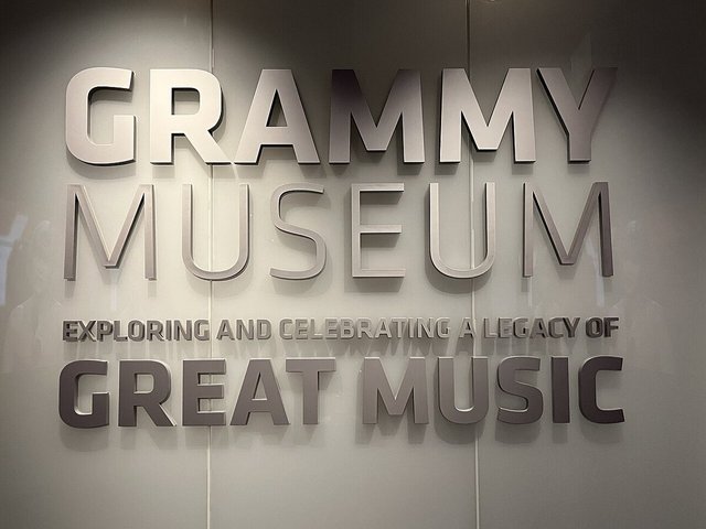 Brushed-metal Grammy Museum lettering on a wall reading Exploring and Celebrating a Legacy of Great Music