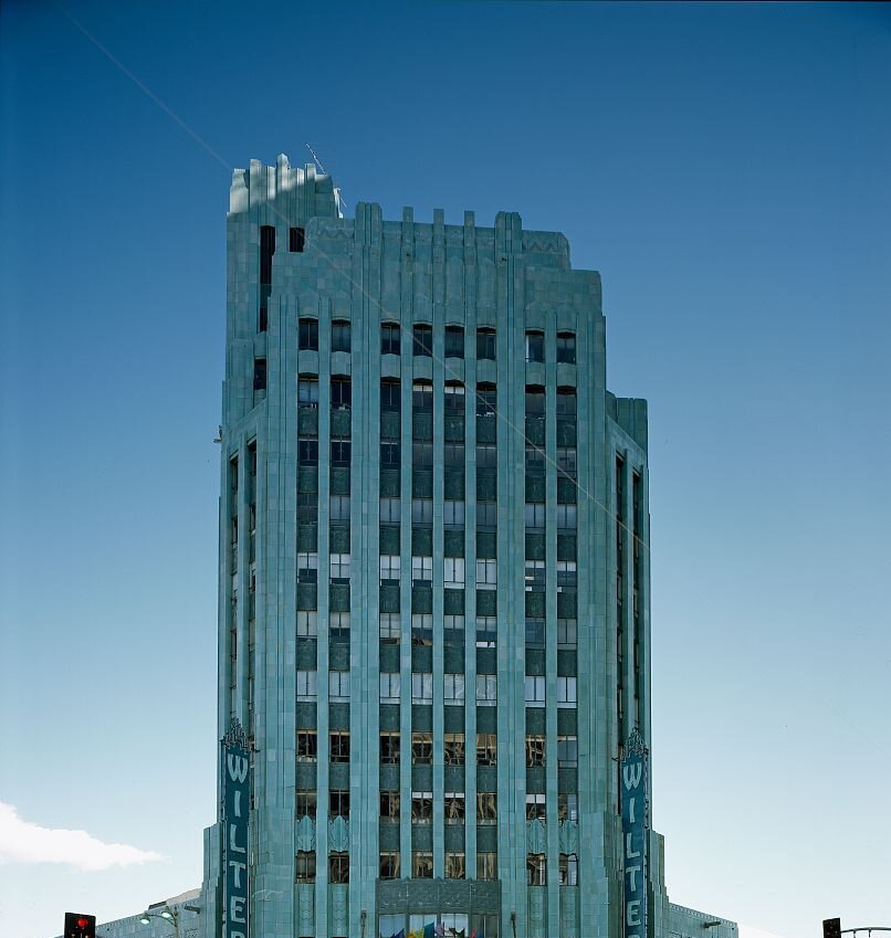 Teal Art Deco tower of The Wiltern theater against a clear blue sky