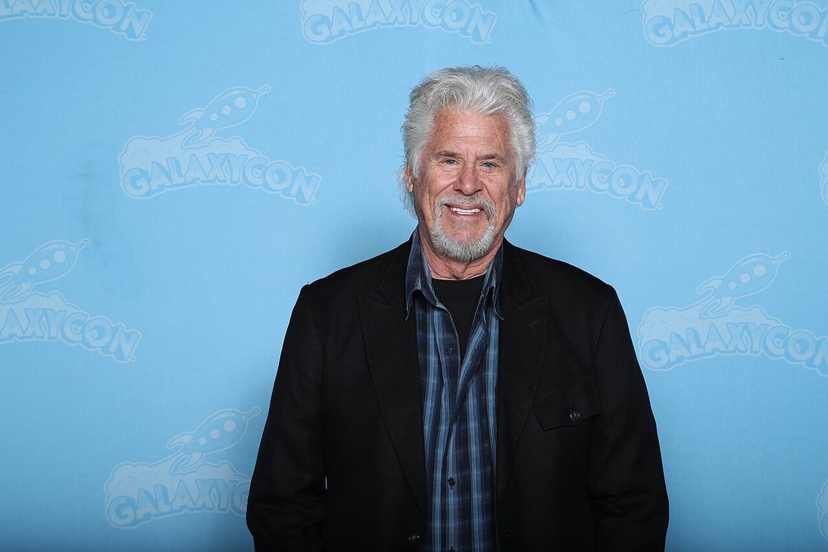 Barry Bostwick smiling at a fan event, wearing a light-colored jacket