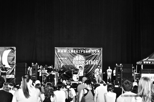 Black-and-white photo of a band on a festival stage in front of a crowd, from a 2009 Senses Fail show