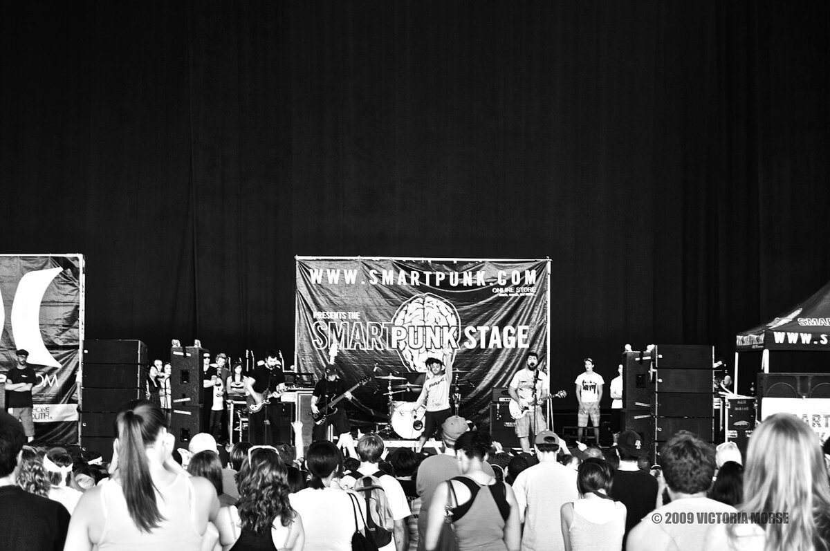 Black-and-white photo of a band on a festival stage in front of a crowd, from a 2009 Senses Fail show