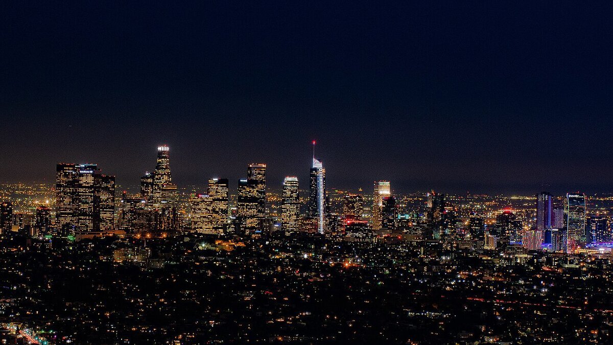 Downtown Los Angeles skyline lit up against a dark night sky