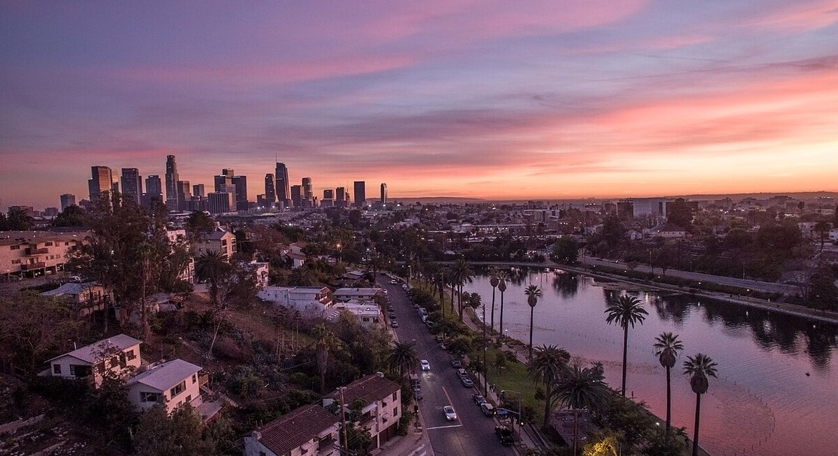 Dusk view over Echo Park Lake and the downtown Los Angeles skyline under a pink and purple sky