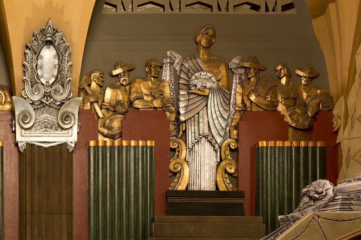 Gilded Art Deco sculptures of workers and a central goddess figure in the lobby of the Hollywood Pantages Theatre