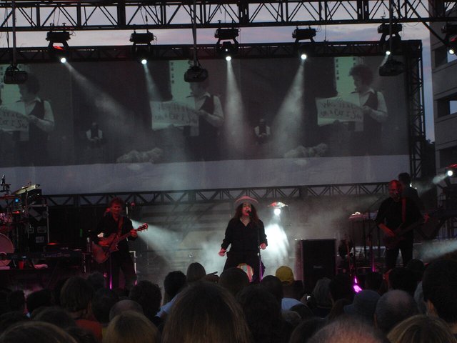 Weird Al Yankovic and his band performing Bob on an outdoor festival stage