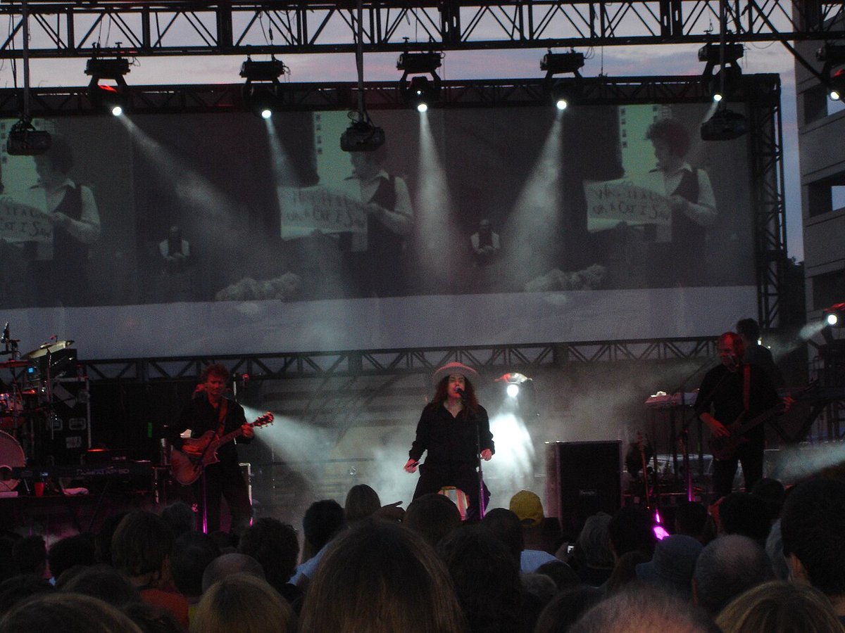 Weird Al Yankovic and his band performing Bob on an outdoor festival stage