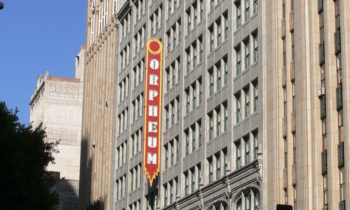 Red vertical Orpheum sign on the building facade on South Broadway in Downtown Los Angeles