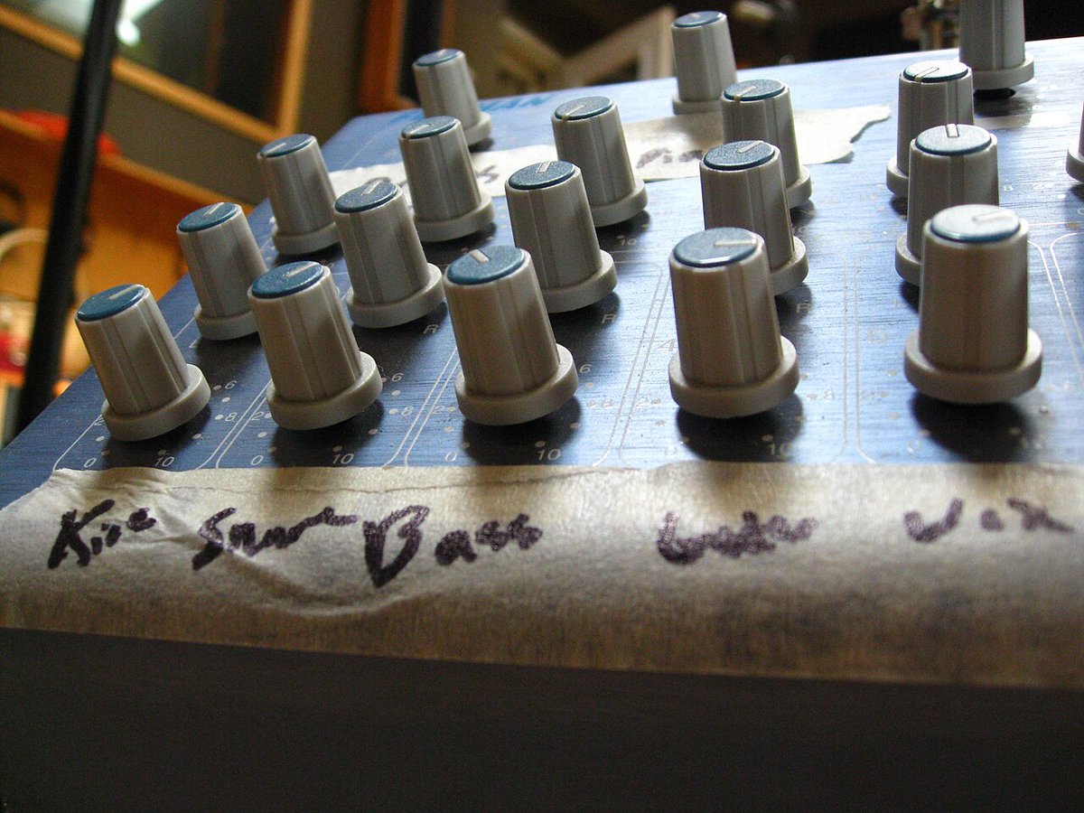 Close-up of a row of grey metal control knobs on a piece of audio equipment