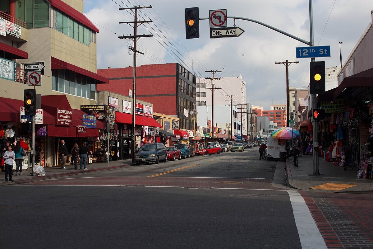 Santee Street in the Los Angeles Fashion District, with shop awnings and traffic lights at 12th Street