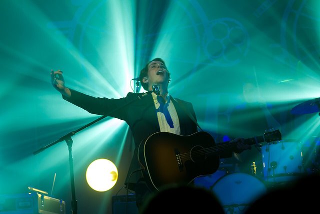 A performer on stage at The Fonda Theatre in Los Angeles with the crowd cheering below