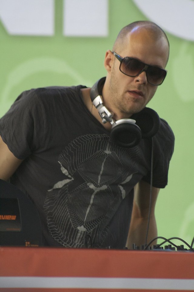 Adam Beyer standing behind DJ equipment during a set