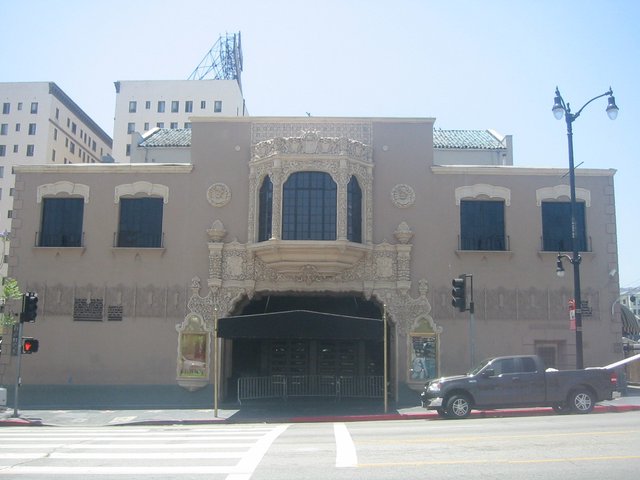 The Spanish Colonial facade and black entrance canopy of the Avalon theater building on Vine Street in Hollywood