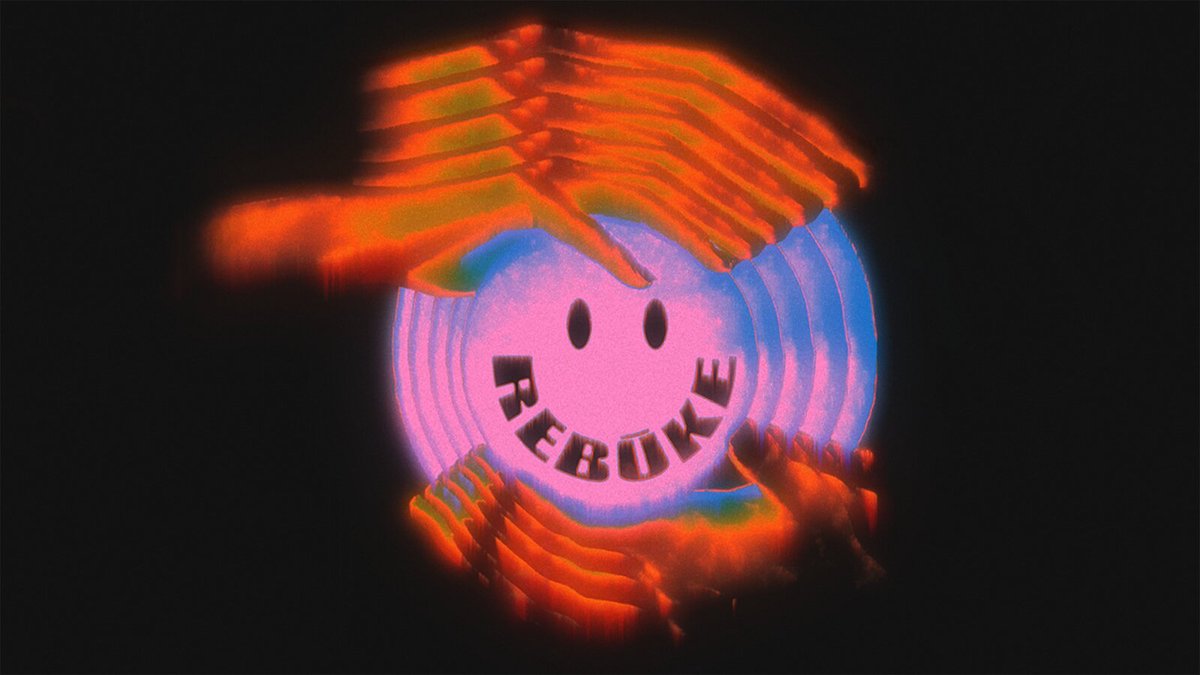 Glowing pink smiley face spelling out Rebūke, with blurred orange hands above and below it on a black background