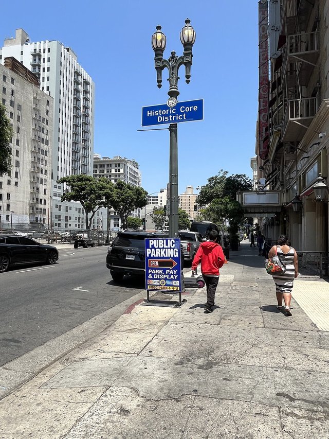 Lamp post with a Historic Core District sign on a sunny Main Street in downtown Los Angeles