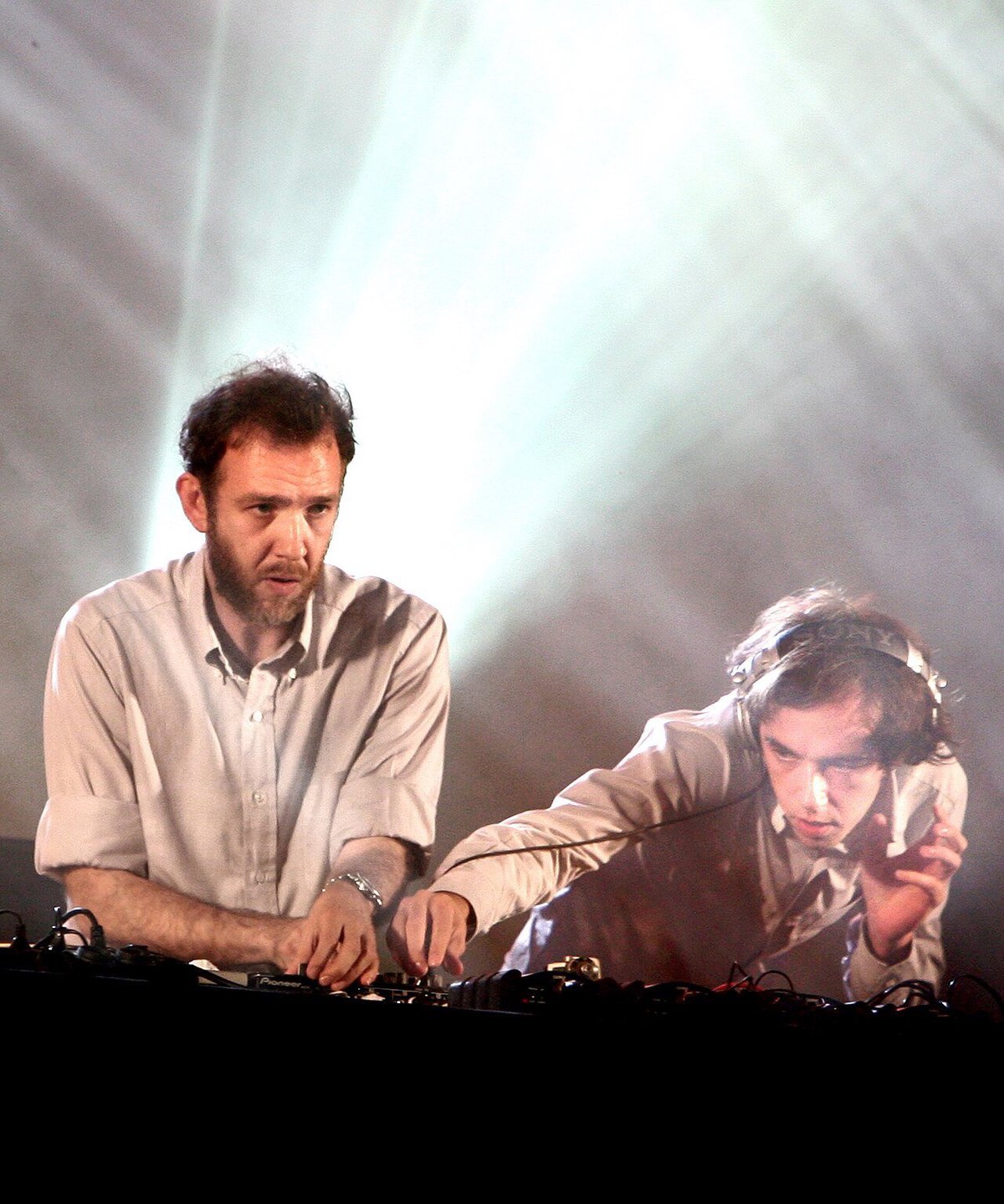 Soulwax performing live on stage, bathed in stage lighting at a festival