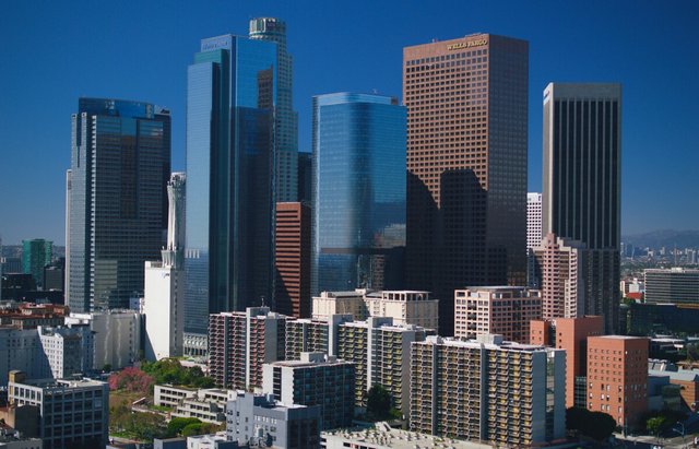 Downtown Los Angeles skyscrapers against a clear blue sky