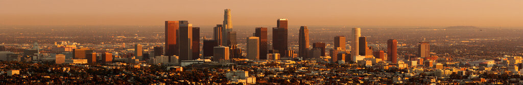 Downtown Los Angeles skyline glowing in orange light at sunset