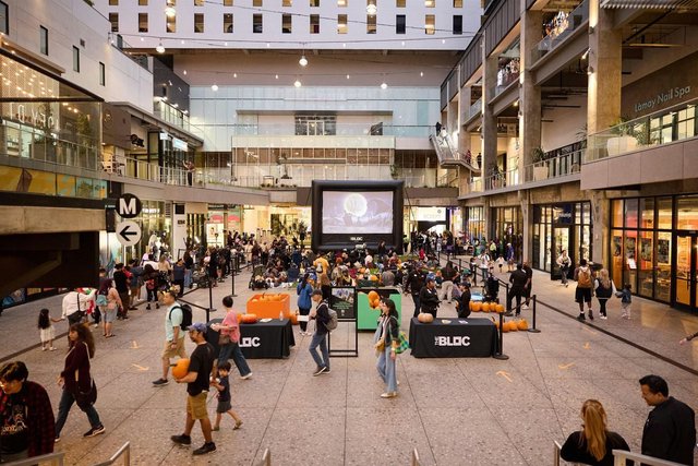 Families gathered in The Bloc's open-air plaza with pumpkins, BLOC-branded tables and an outdoor movie screen