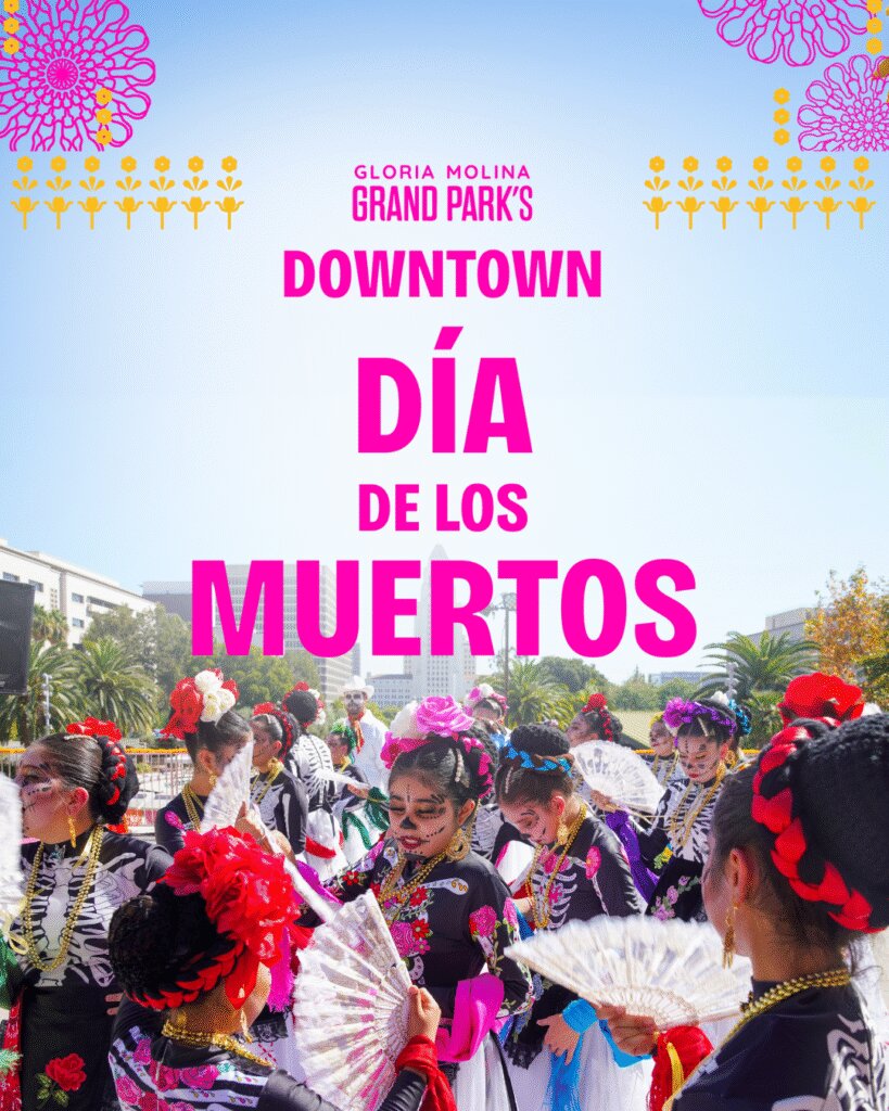 Dancers in skeleton-print dresses, face paint and flower headpieces holding fans, with Downtown LA buildings and the event title behind them